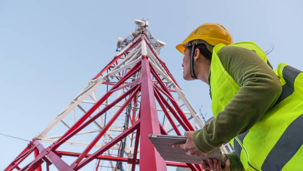 istock Female Engineer working on the field near a Telecommunications tower. 1213293204