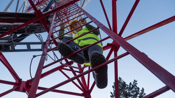 istock Female Engineer working on the field near a Telecommunications tower. 1213293221