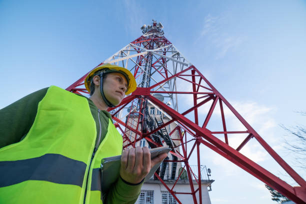 istock Female Engineer working on the field near a Telecommunications tower. 1213293267
