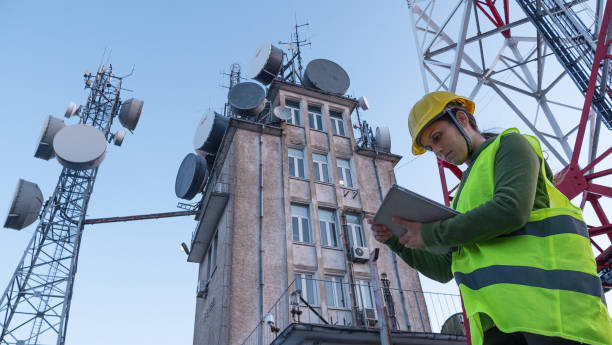 istock Female Engineer working on the field near a Telecommunications tower. 1213293510
