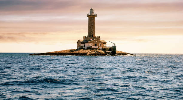istock beautiful sunset over a lighthouse in Croatia 1213295508