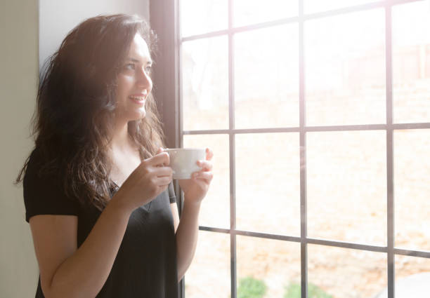 istock Thinking woman in front of the window 1213295637