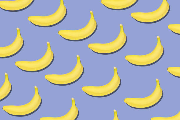 istock Colorful fruit pattern of fresh yellow bananas on blue background. 1213296182