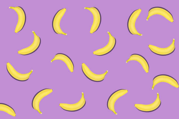 istock Colorful fruit pattern of fresh yellow bananas on violet background. 1213296206