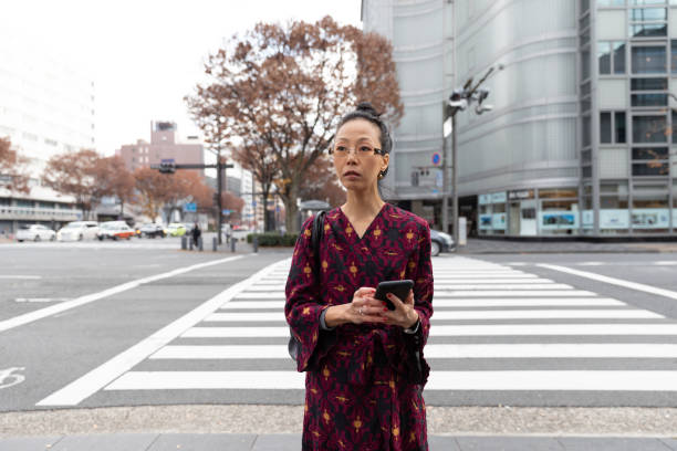 istock Japanese business worman walking with suitcase 1213296354