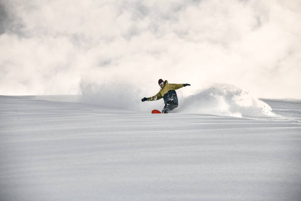 istock Freerider on a snowboard slipping on a snowy mountain side 1213296440
