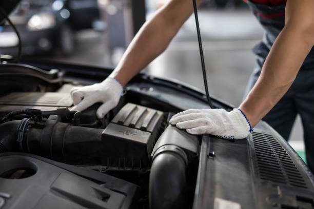istock Male hand repairing car engine at servics 1213296454
