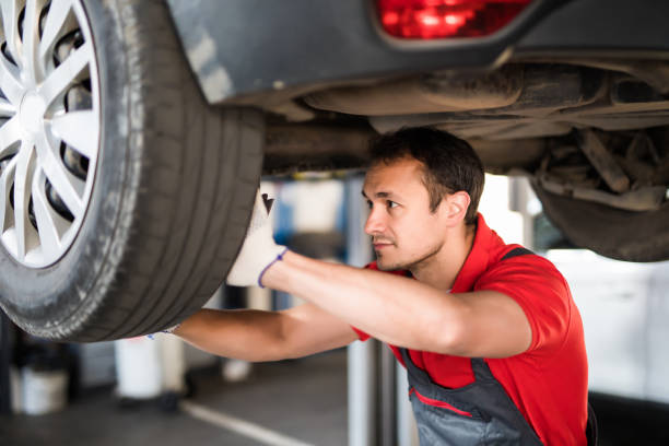 istock Handsome man mechanic with tool checking the car 1213296692