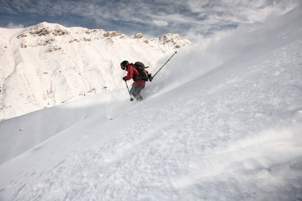 istock Smiling skiier gliding down the mountain side 1213297684