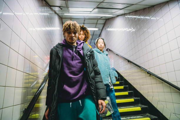 istock Three friends coming down the stairs in subway 1213297962