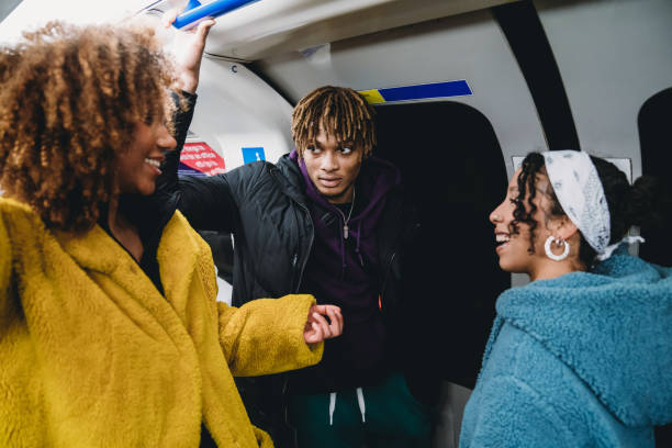 istock Young adult friends talking together inside a subway train 1213297986