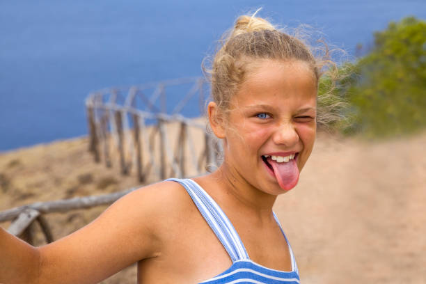 Young Girl making a funny face to the camera during summer vacations