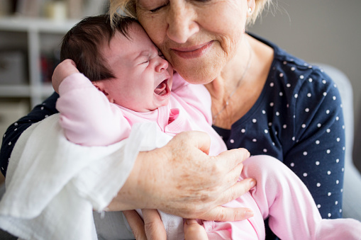 Grandmother consoling her baby granddaughter