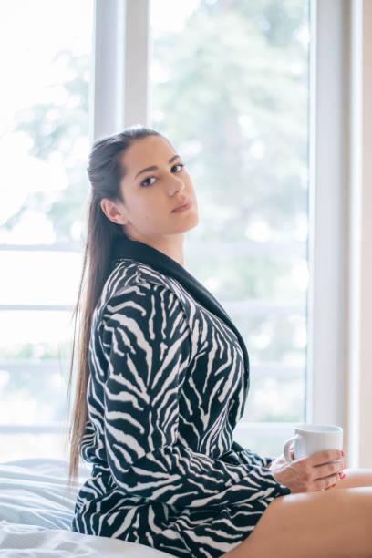 istock Beautiful woman siting comfortable and enjoys coffee 1213302320