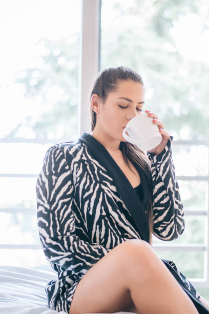 istock Beautiful woman siting comfortable and enjoys coffee 1213302387