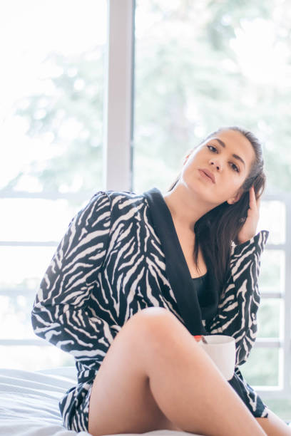 istock Beautiful woman siting comfortable and enjoys coffee 1213302402