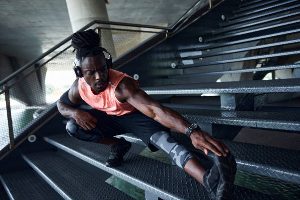 istock Muscular man stretch on a staircase 1213302761