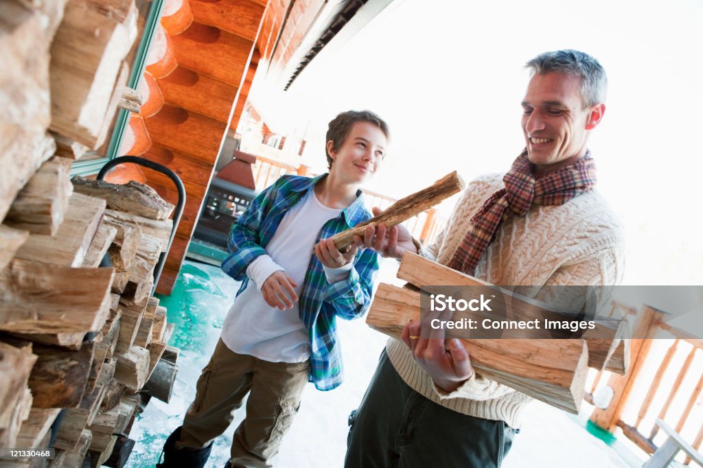 Father Log Father And Son Holding Logs Stock Photo - Download Image Now - Father ...