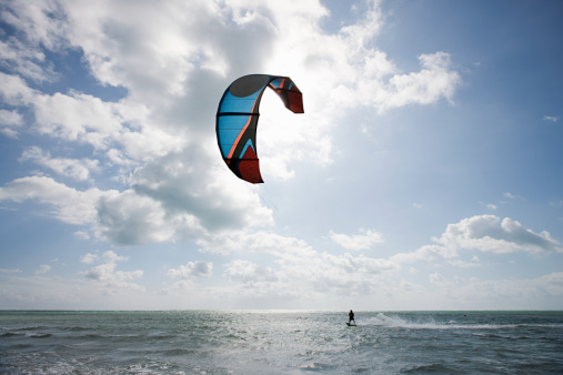 Tarifa beach in Cadiz surf city skyline of Andalusia Spain with lots of kitesurfing kites under blue sunny sky