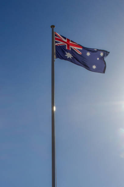 istock Australian flag slowly waving on the beautiful blue sky 1213305583