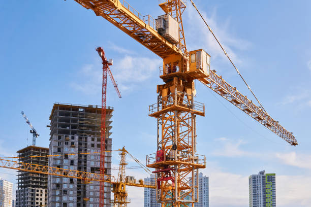 istock construction tower cranes on a building site against the sky 1213305956