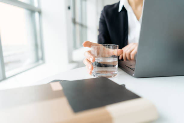 istock Female hand holding glass with still water 1213309257