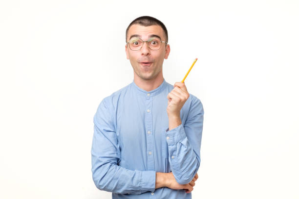 istock Young hispanic man in glasses is thinking about something with pencil 1213309666