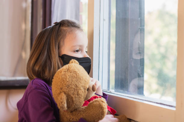 istock Child whit protective mask indoors 1213309990