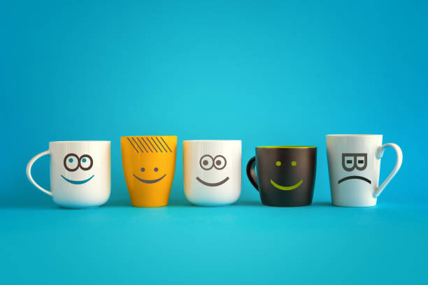 Coffee Cups with Happy and Sad Emoticons Coffee Cups with Happy and Sad Emoticons - Conceptual Image for Business Team Coffee Break with Copy Space tea cup photos stock pictures, royalty-free photos & images