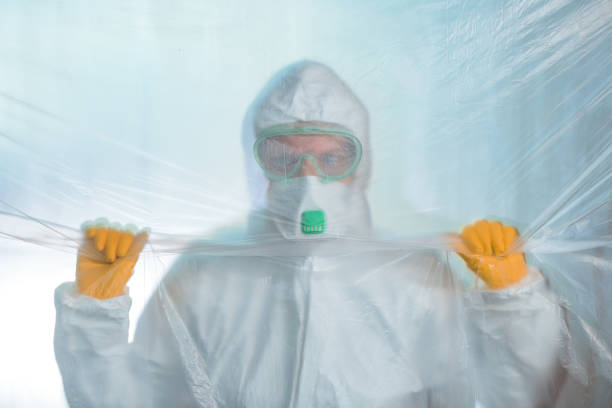 istock Worried exhausted epidemiologist trapped behind plastic curtain in virus quarantine 1213310917
