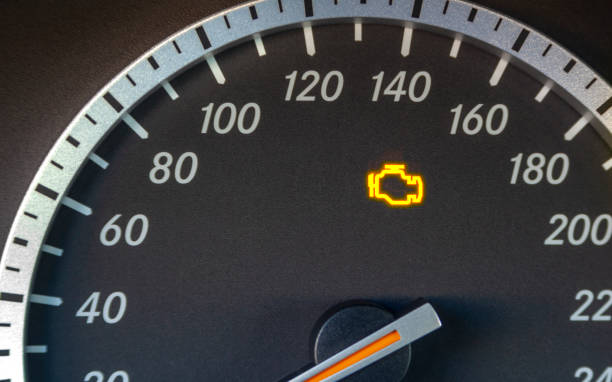 Engine failure symbol lights up in the dashboard of the car Engine failure symbol lights up in the dashboard of the car dashboard close up speedometer odometer stock pictures, royalty-free photos & images