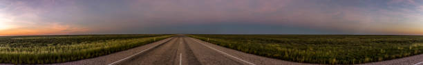 panorama of a straight road through the outback of Australia, after a beautiful sunset, Nothern territory panorama of a straight road through the outback of Australia, after a beautiful sunset downunder stock pictures, royalty-free photos & images