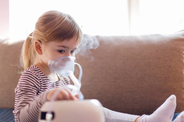 istock Serious young girl on inhalation 1213316855