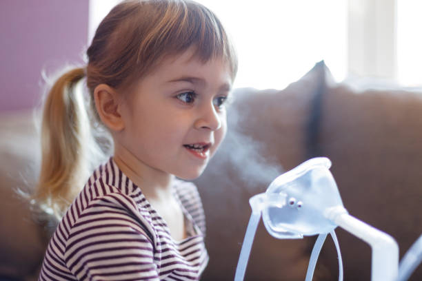 istock Smiling child holding inhaler 1213316873