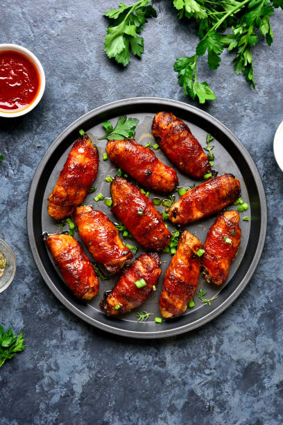istock Bacon wrapped grilled chicken wings 1213318733