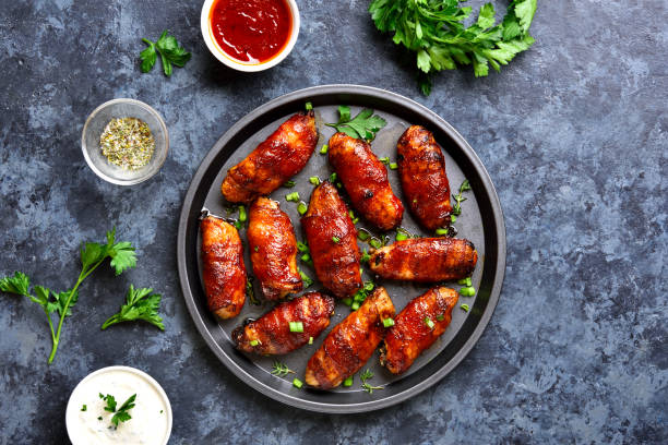 istock Bacon wrapped grilled chicken wings 1213318781