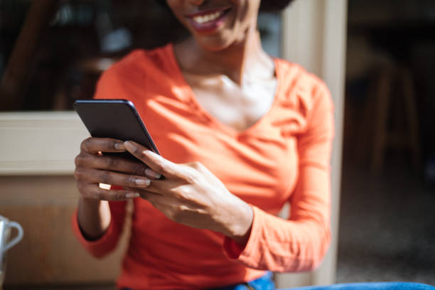 istock Beautiful woman using phone at cafe 1213319549
