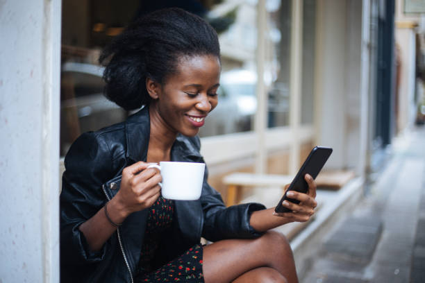 istock Beautiful woman using phone at cafe 1213319787