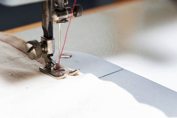 istock Shuttle a needle. Part of the sewing machine close-up 1213320113