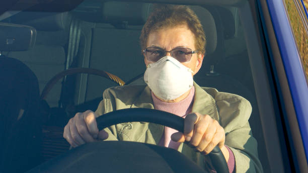 istock CLOSE UP: Elderly woman wears facemask while driving during coronavirus outbreak 1213321380