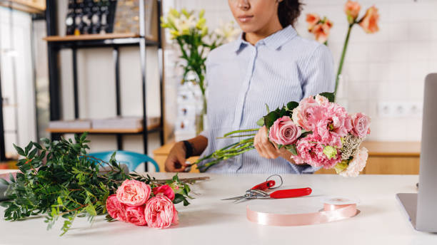 istock Unrecognizable florist with bouquet at counter 1213324023