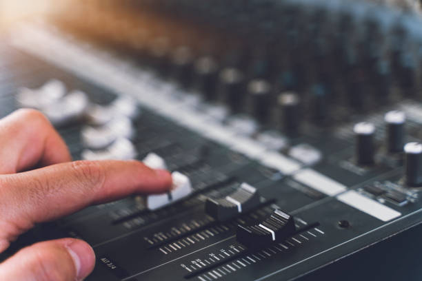 istock Professional audio mixing console with faders and adjusting knobs - radio / TV broadcasting 1213325528