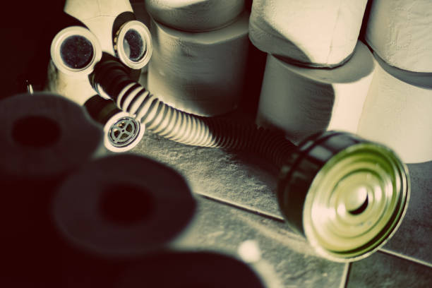 Vintage gas mask and toilet paper stockpile.