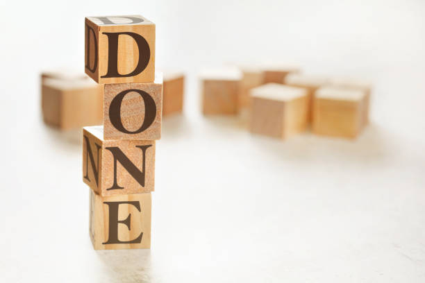istock Four wooden cubes arranged in stack with word DONE on them, space for text / image at down right corner 1213333226