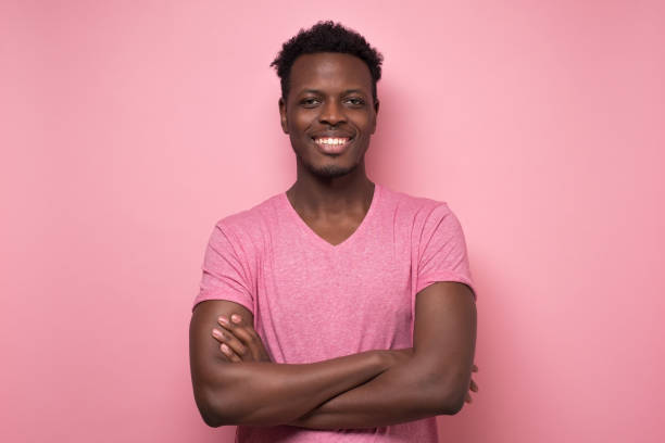 istock Smiling young african american man with folded hands looking at camera. 1213334206