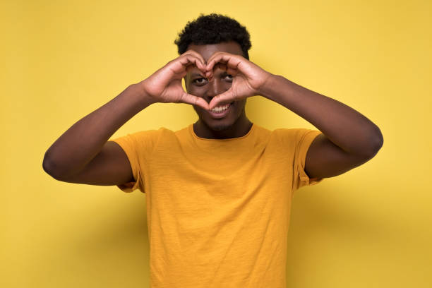 istock Handsome african american guy making heart shape with his hands 1213335633