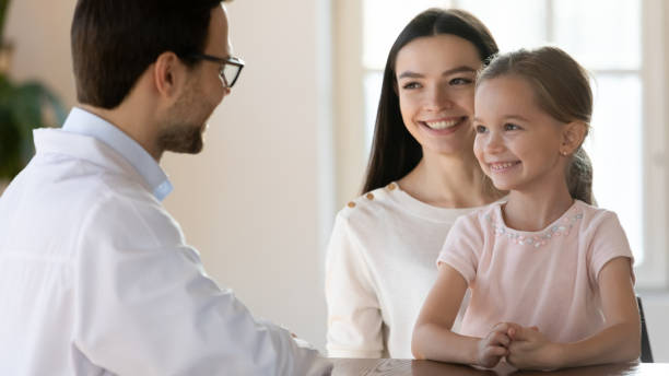 istock Happy young mother visiting pediatrician with daughter. 1213336894