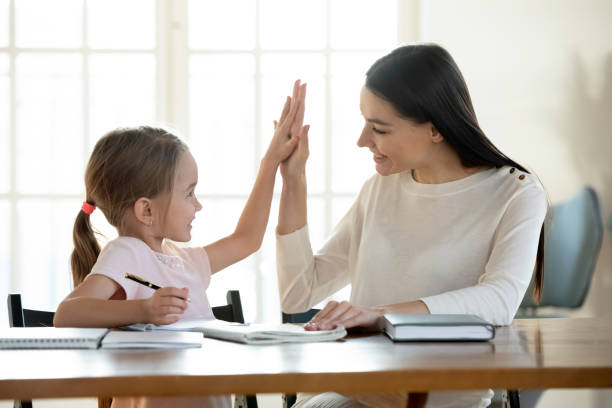 istock Joyful small daughter giving high five to mom. 1213336947