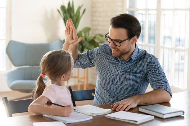 istock Happy young daddy giving high five to smiling little daughter. 1213336955