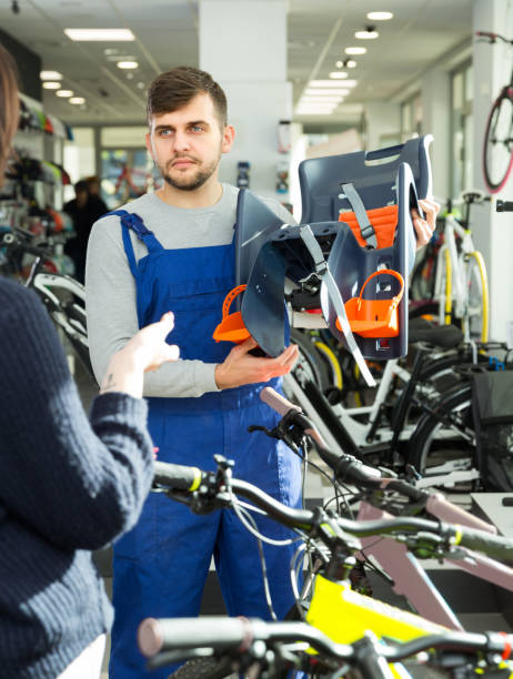 istock Glad seller demonstrating bicycle sit for child 1213337113